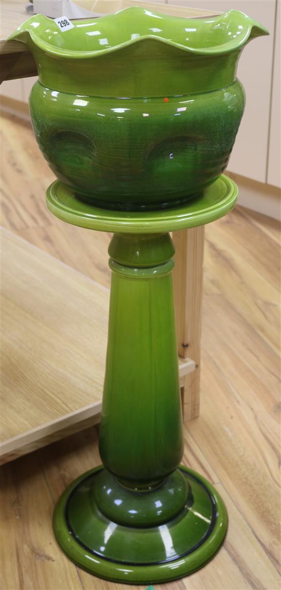 A green Bretty pottery jardiniere, on pedestal